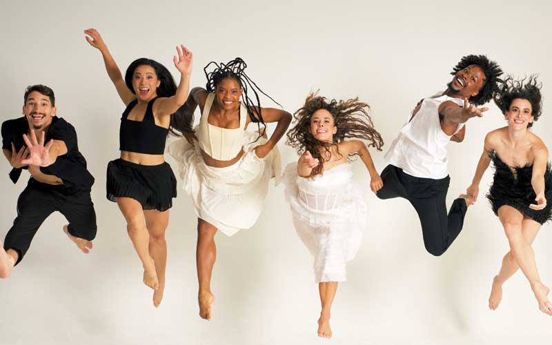 A group of people jumping and smiling.